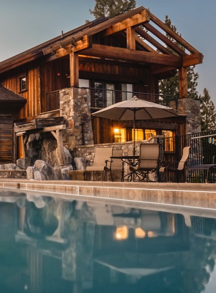 Wooden Log style house with a pool in the foreground